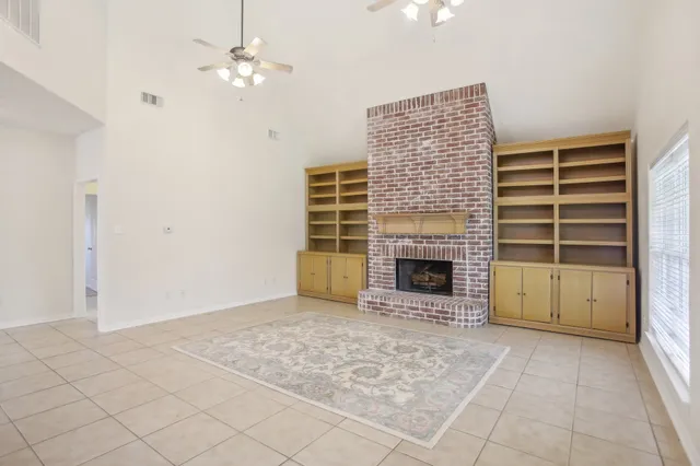 a view of an empty room with a fireplace