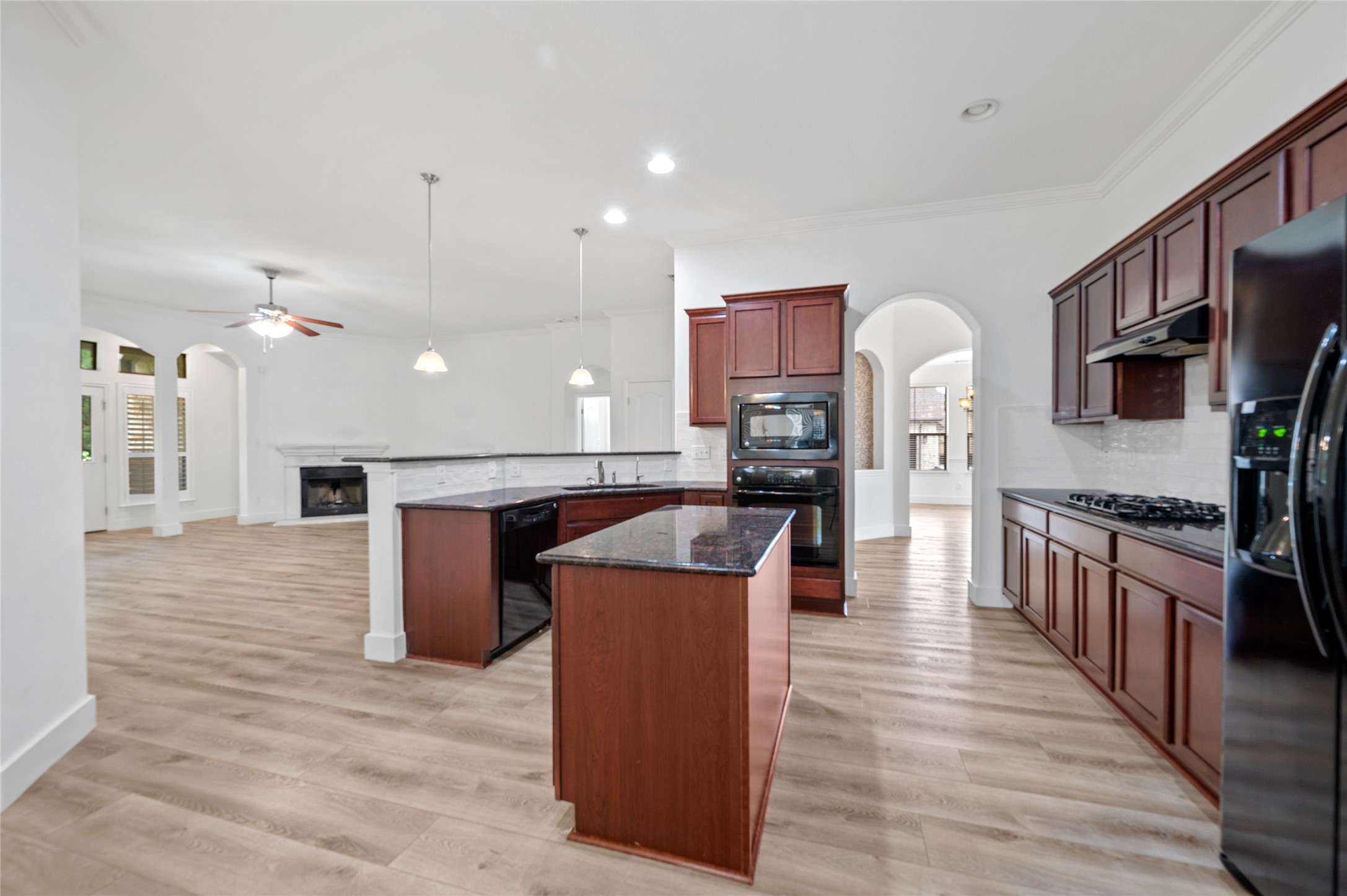 4512 Pyrenees Pass Bee Cave, TX 78738 - Photo 9 of 35 a kitchen with stainless steel appliances kitchen island wooden cabinets and granite counter tops