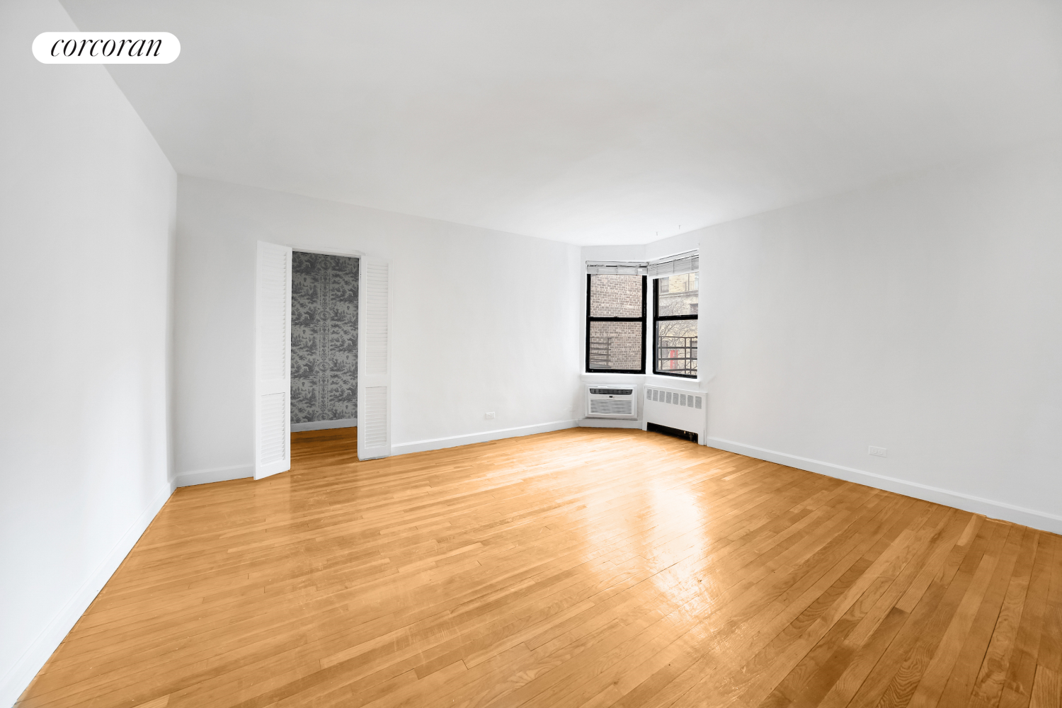 330 East 70th Street, Unit 5G Manhattan, NY 10021 - Photo 2 of 17 a view of an empty room with window and wooden floor