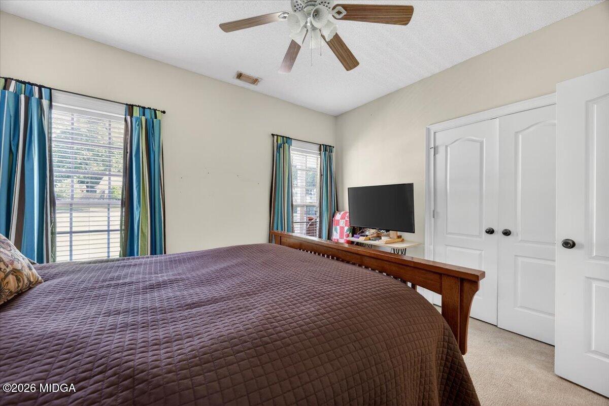 619 Grayridge Road Gray, GA 31032 - Photo 23 of 40 a bedroom with a bed and a flat screen tv