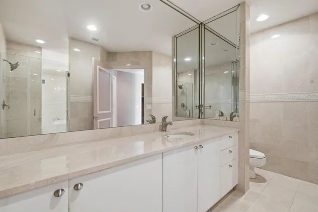 an aerial view of ocean and residential houses with outdoor space