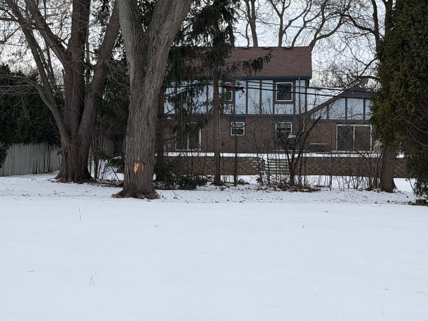 2334 Corona Road Beach Park, IL 60087 - Photo 2 of 4 a front view of a house with a yard covered in snow