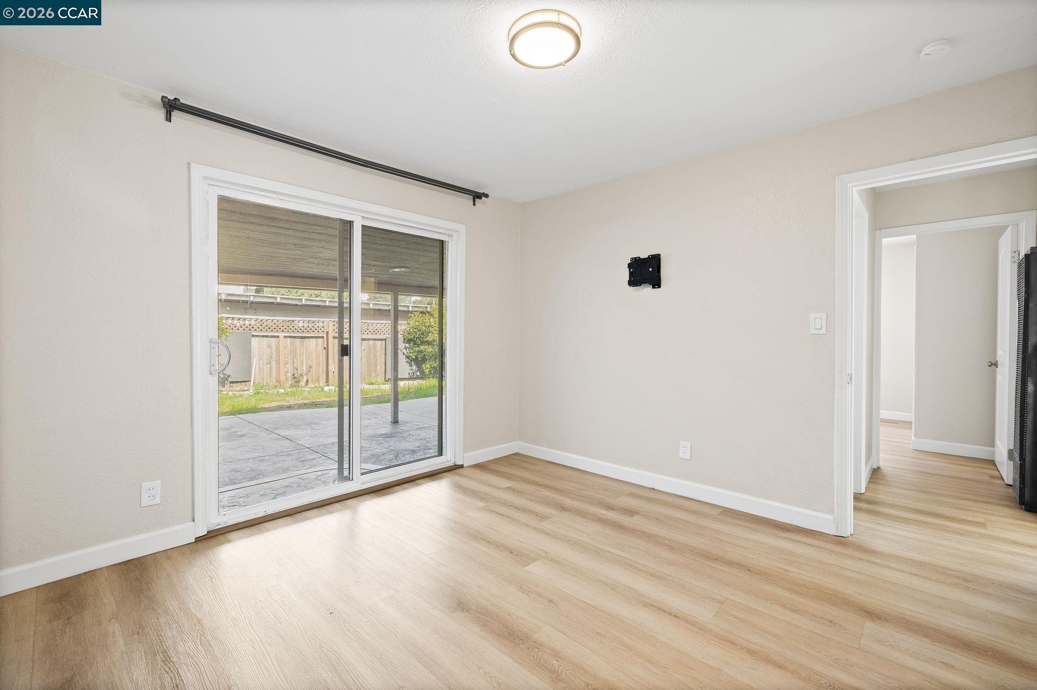 4820 Blum Road Martinez, CA 94553 - Photo 15 of 46 an empty room with wooden floor and windows