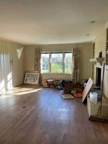 a living room with furniture and a hard wood floor