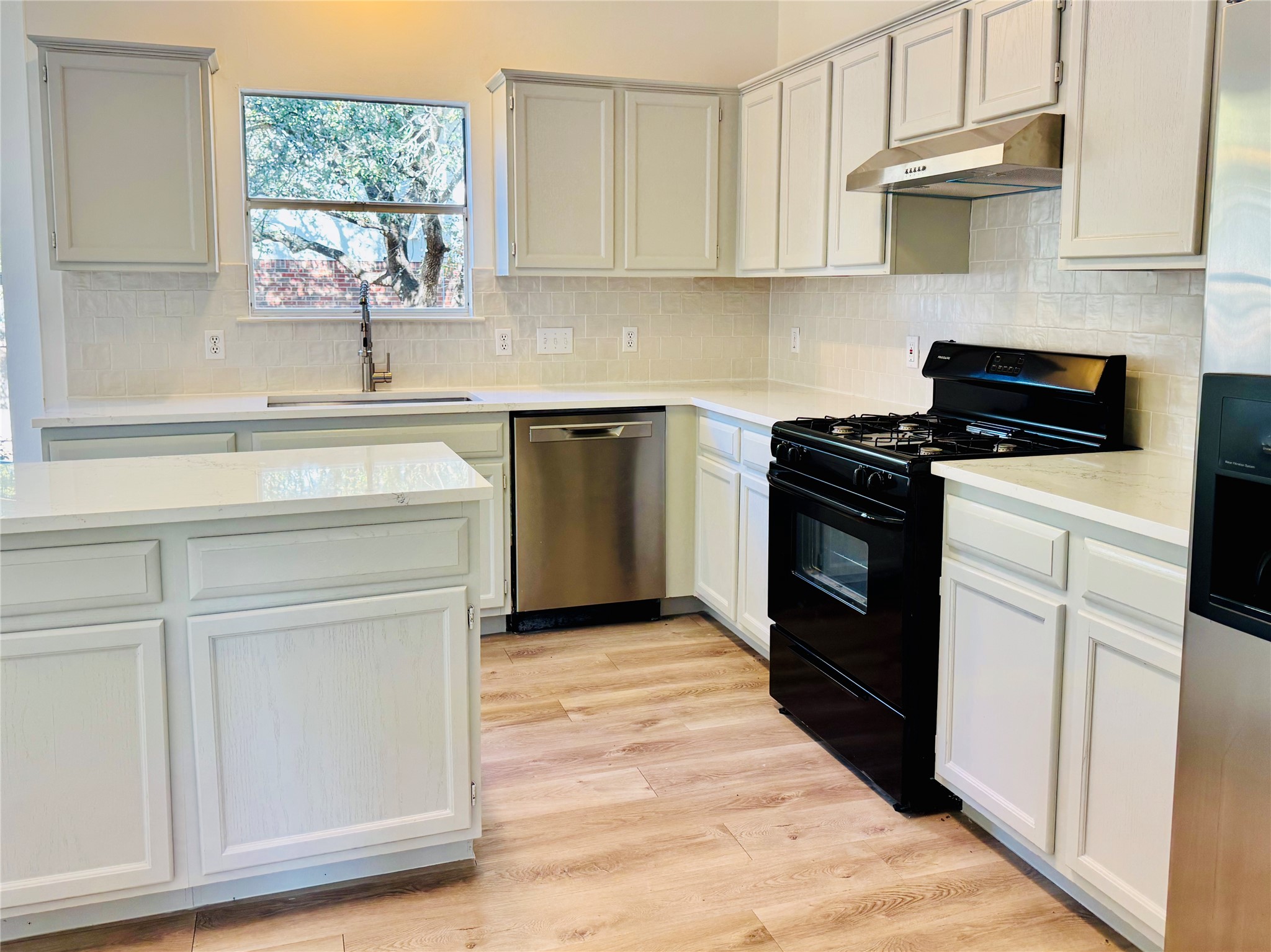 2113 Lobelia Drive Cedar Park, TX 78613 - Photo 13 of 38 a kitchen with cabinets appliances and a window