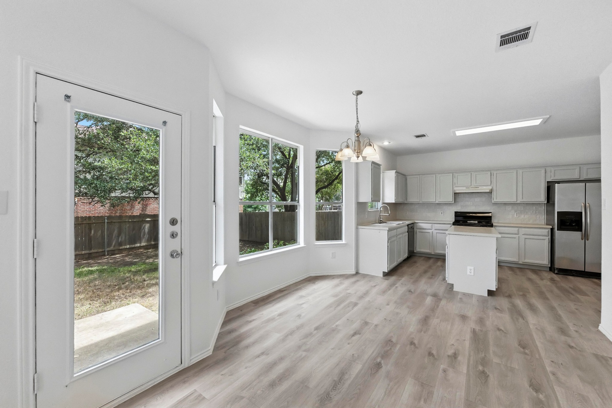 2113 Lobelia Drive Cedar Park, TX 78613 - Photo 15 of 38 a open kitchen with white cabinets and wooden floor