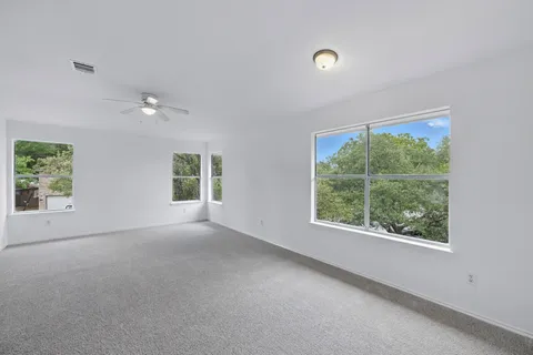 an empty room with windows and closet