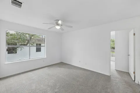a view of an empty room with a ceiling fan