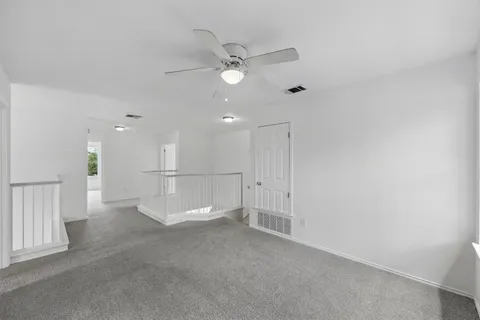 a view of empty room with ceiling fan