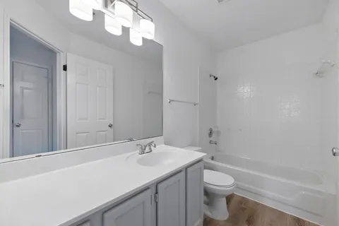 an empty room with a window and a ceiling fan