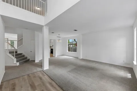 a view of a livingroom with an empty space and a window