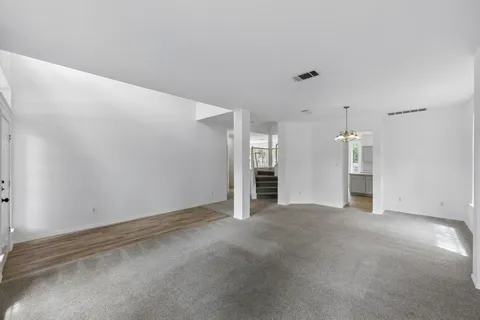 a view of an empty room with closet