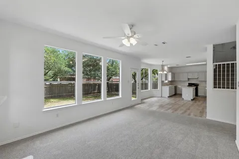 a view of an empty room with a fireplace and a large window