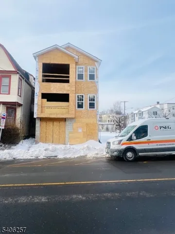 a white car parked in front of a house