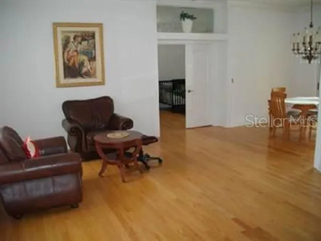 a living room with furniture and a piano