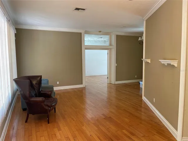 a view of room with furniture and wooden floor