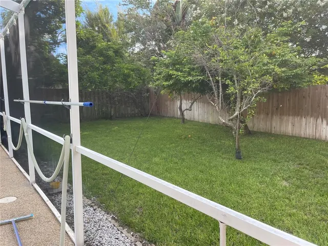 a backyard of a house with lots of green space and plants