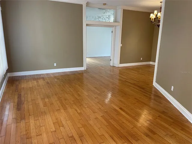 a kitchen with sink cabinets and chandelier