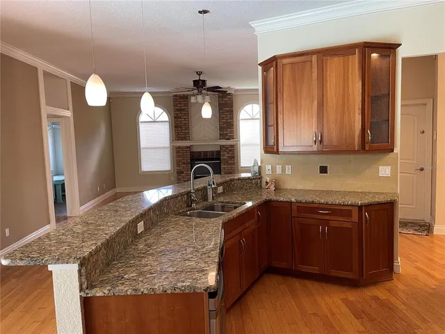 a kitchen with stainless steel appliances granite countertop a sink stove and cabinets