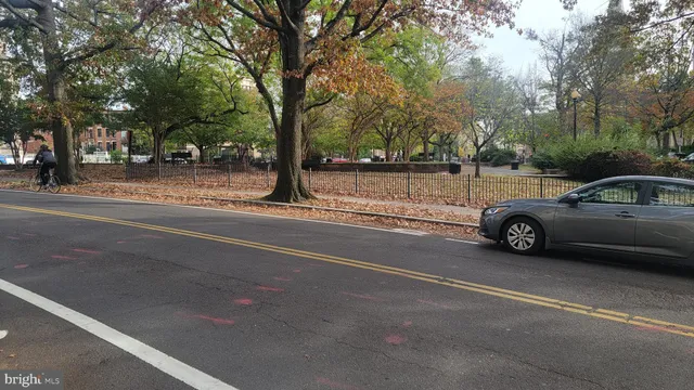 a view of car parked on the side of a street