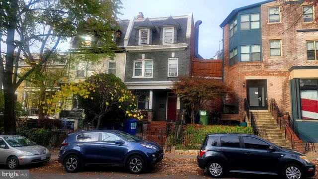 a car parked in front of a brick house