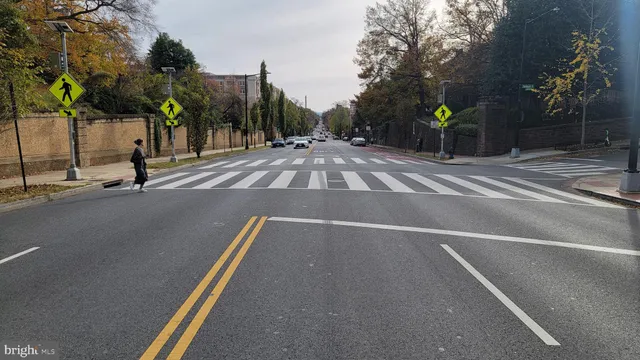a view of a street with a building in the background