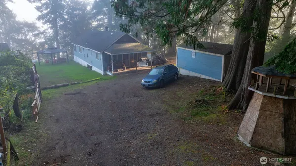 a view of a house with backyard and trees