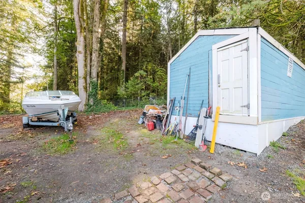 a backyard of a house with barbeque oven table and chairs