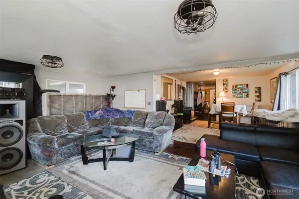 a living room with furniture a rug and a window