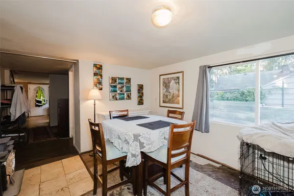 a dining room with furniture and window