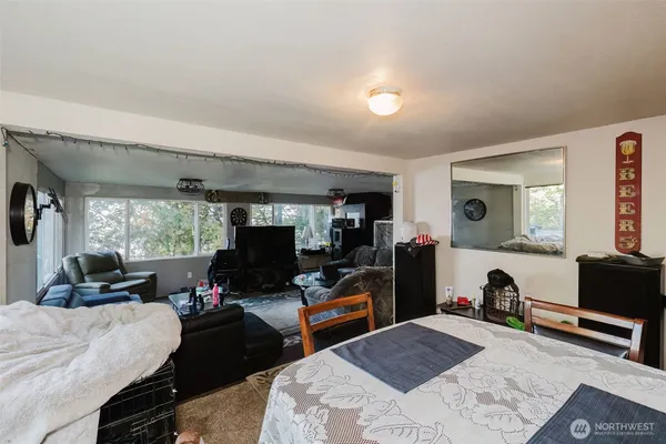 a bedroom with a bed and a flat tv screen