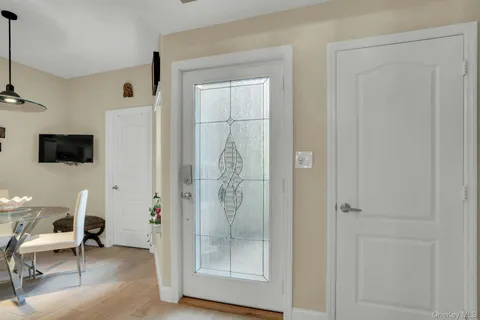 a view of a hallway with wooden floor and door