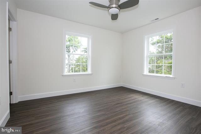 2 5th Street Del Haven, NJ 08251 - Photo 23 of 24 an empty room with wooden floor chandelier fan and windows
