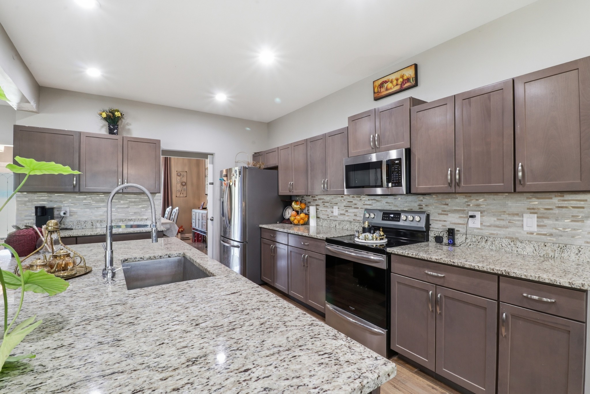 126 Savannah Ridge Murfreesboro, TN 37127 - Photo 13 of 50 a kitchen with granite countertop a sink stainless steel appliances and counter space