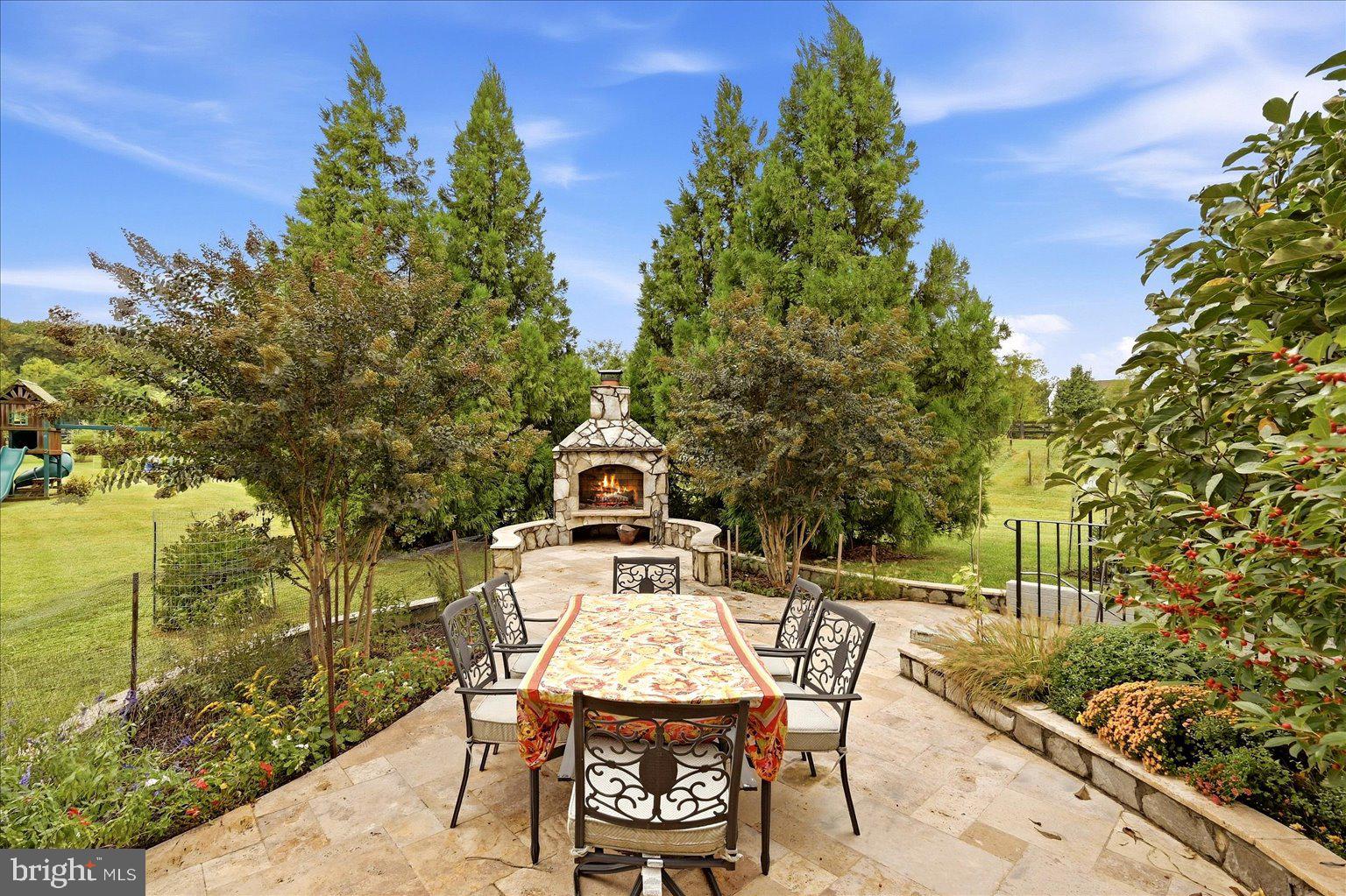 15547 Montresor Road Leesburg, VA 20176 - Photo 62 of 92 Travertine patio dining by the fireplace