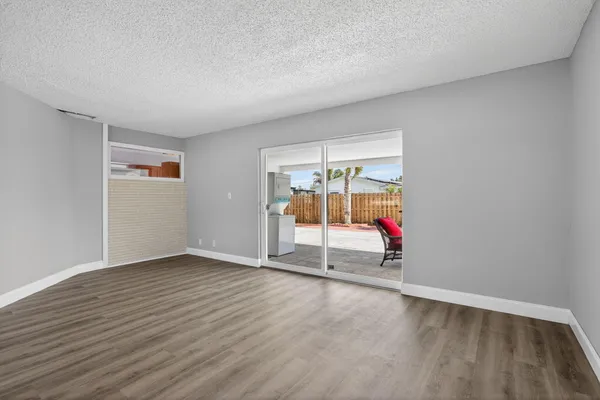 an empty room with wooden floor and white walls
