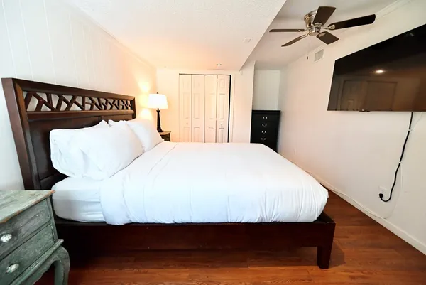 a bedroom with a bed and a flat screen tv