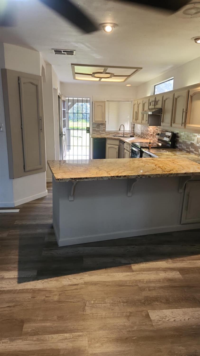 602 South Spruce Road Exeter, CA 93221 - Photo 16 of 28 a view of kitchen with wooden floor