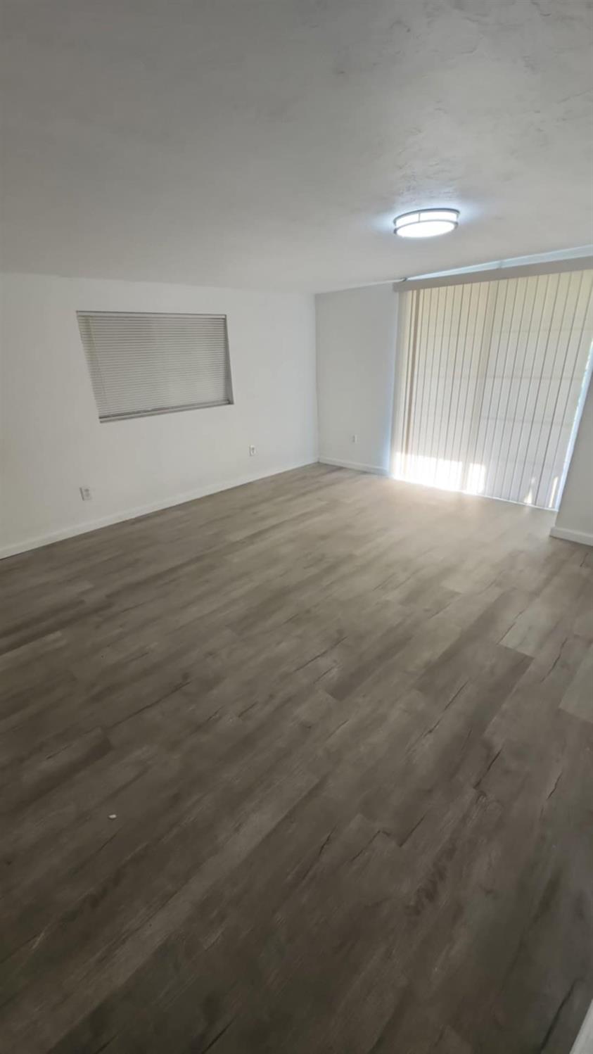 602 South Spruce Road Exeter, CA 93221 - Photo 21 of 28 an empty room with wooden floor and windows