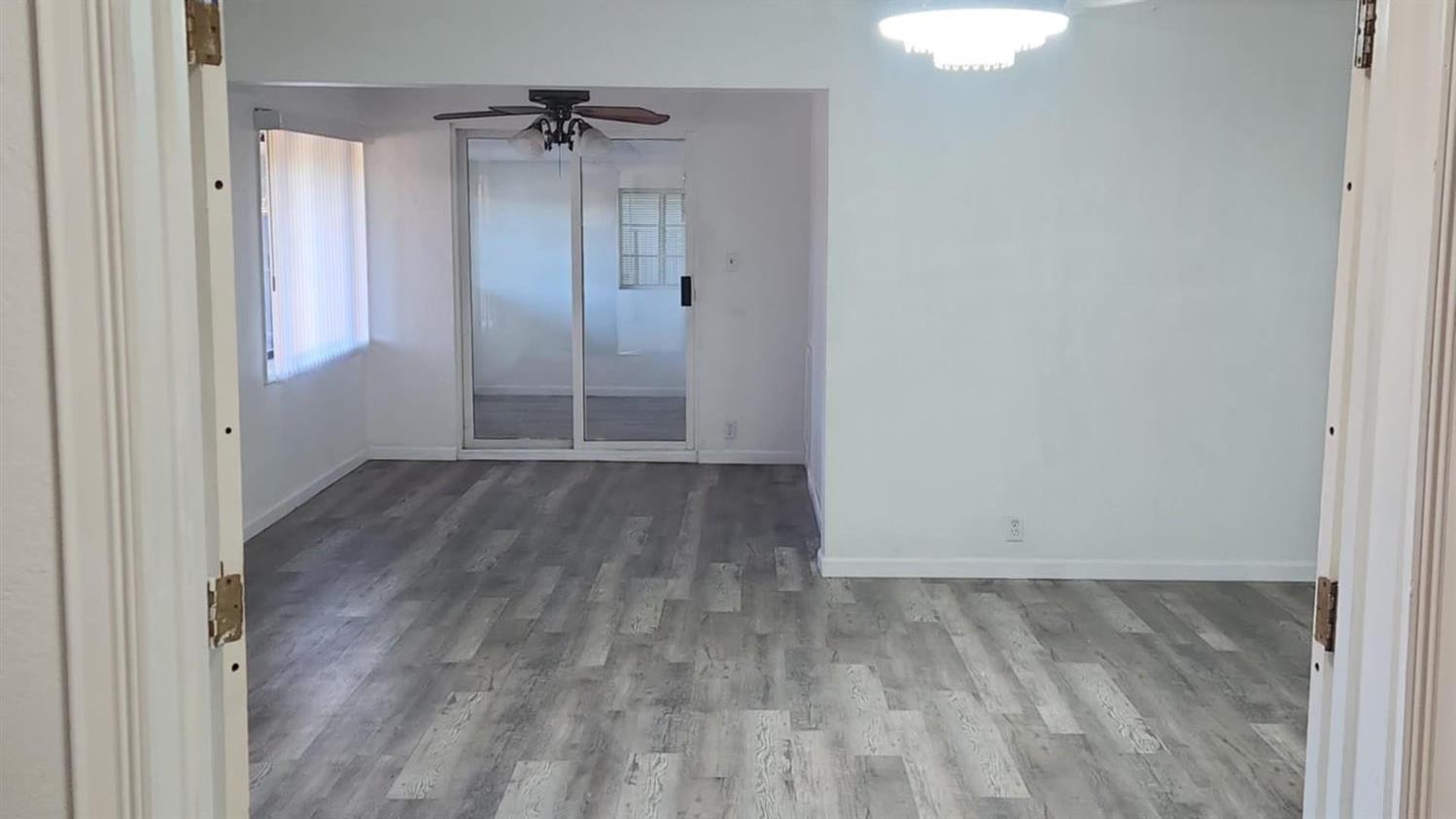 602 South Spruce Road Exeter, CA 93221 - Photo 28 of 28 an empty room with wooden floor and a ceiling fan