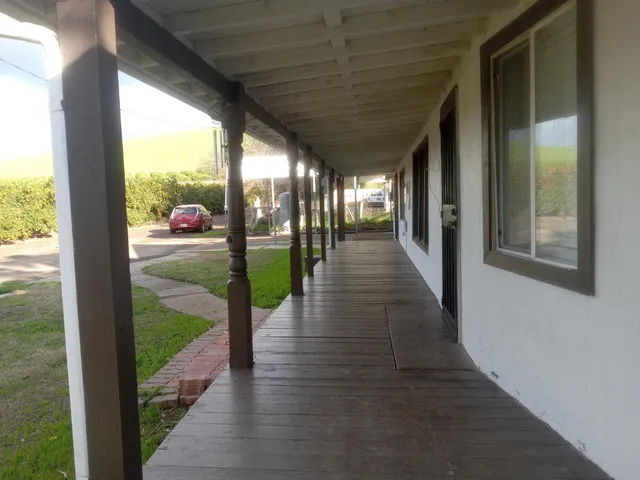 a backyard of a house with table and chairs