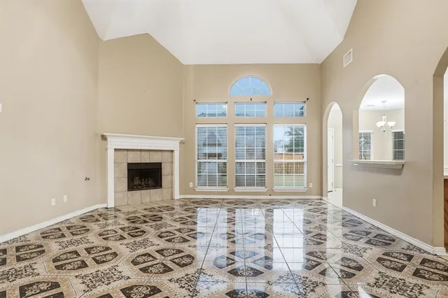 a view of a livingroom with wooden floor and a fireplace