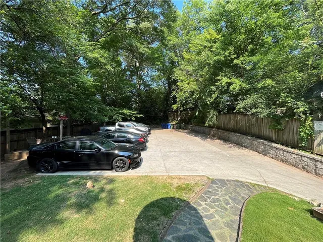 a backyard of a house with table and chairs a fire pit