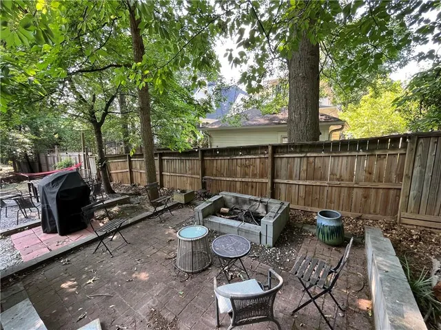 a view of a chairs and tables in the back yard of the house