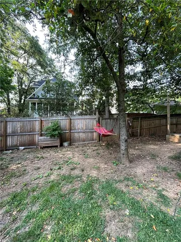 a backyard of a house with swing and slide