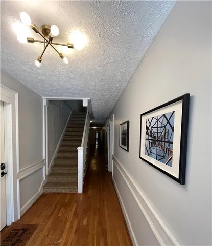 a view of an entryway with wooden floor