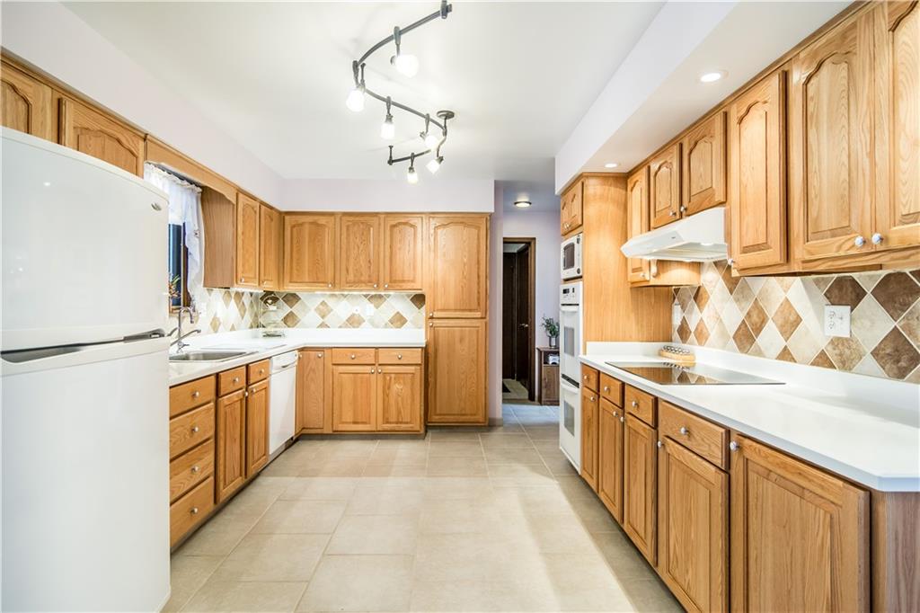 125 Sunset Drive Canonsburg, PA 15317 - Photo 8 of 25 a kitchen with stainless steel appliances granite countertop a refrigerator a sink dishwasher a stove with white cabinets and wooden floor