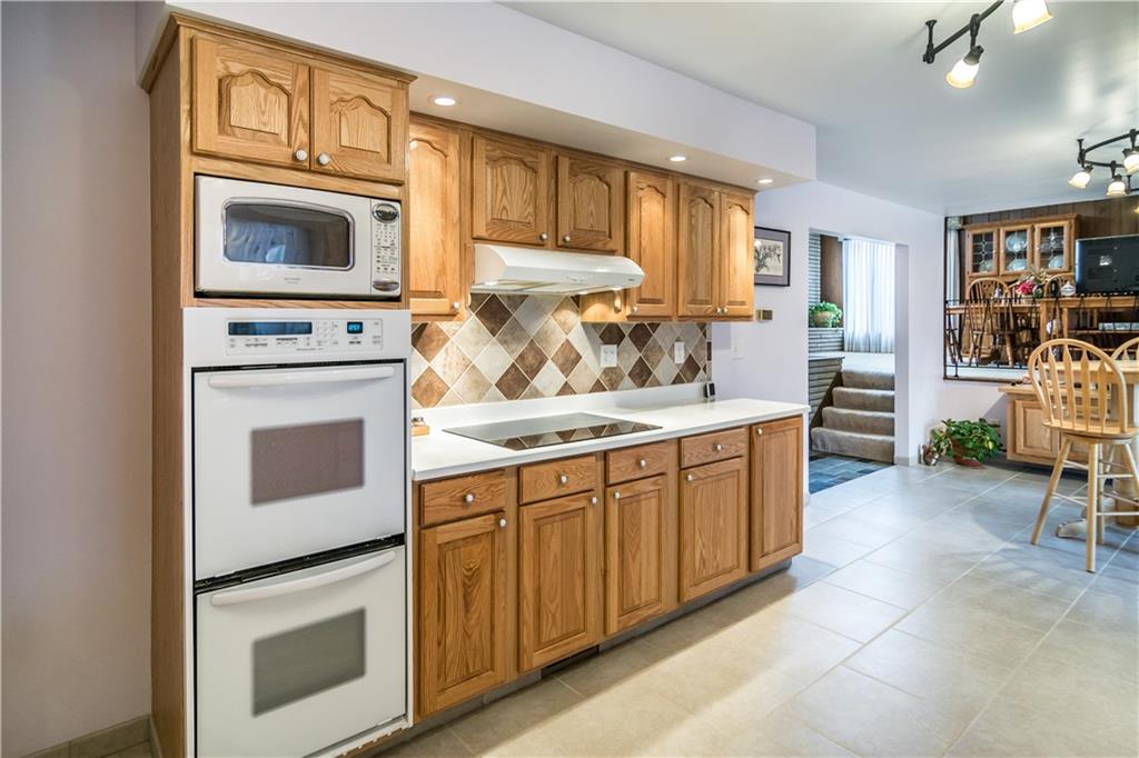 125 Sunset Drive Canonsburg, PA 15317 - Photo 9 of 25 a kitchen with granite countertop a stove top oven microwave and cabinets