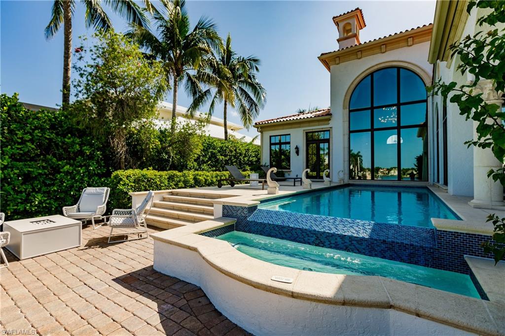 2450 Tarpon Road Naples, FL 34102 - Photo 13 of 26 a view of house with swimming pool and outdoor seating