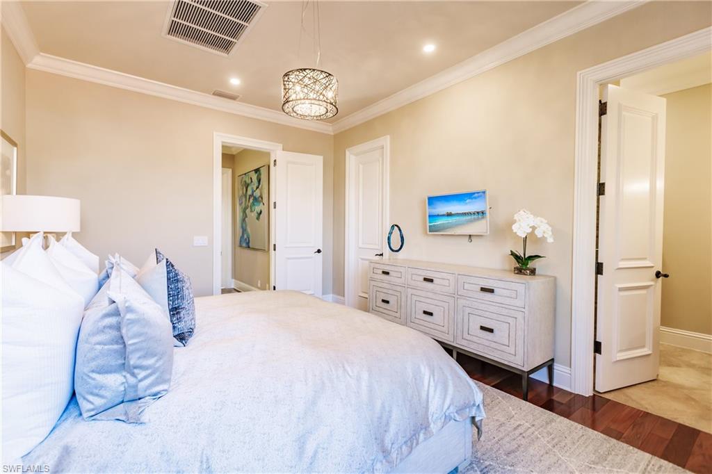 2450 Tarpon Road Naples, FL 34102 - Photo 22 of 26 a bedroom with a bed and a dresser